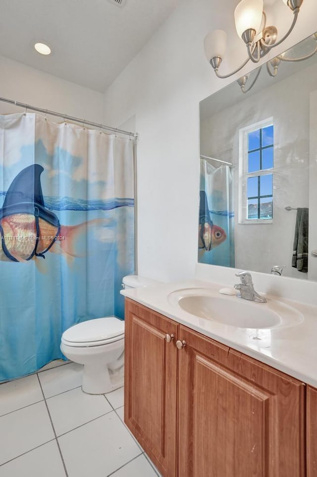 bathroom featuring curtained shower, tile patterned floors, a chandelier, toilet, and vanity