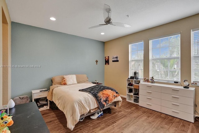 bedroom with ceiling fan and light hardwood / wood-style flooring