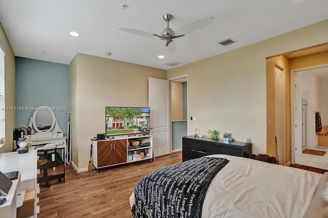 bedroom with light wood-type flooring and ceiling fan