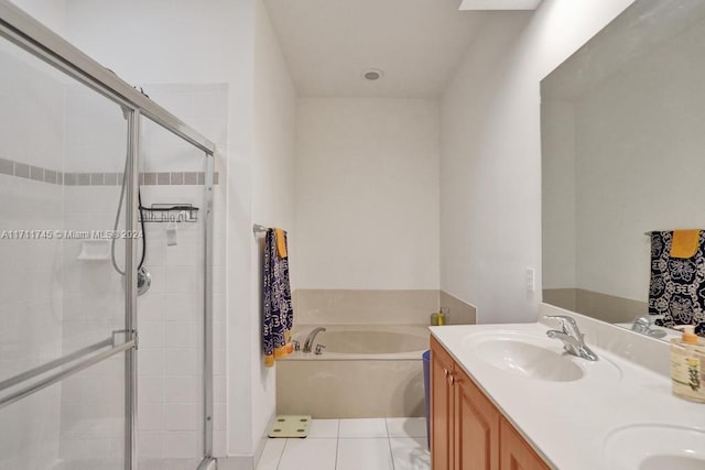 bathroom featuring plus walk in shower, tile patterned flooring, and vanity