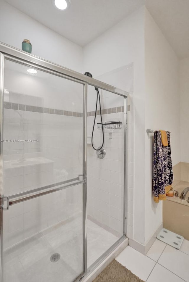 bathroom with tile patterned flooring and walk in shower