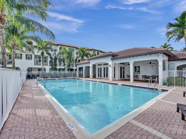 view of swimming pool with ceiling fan and a patio