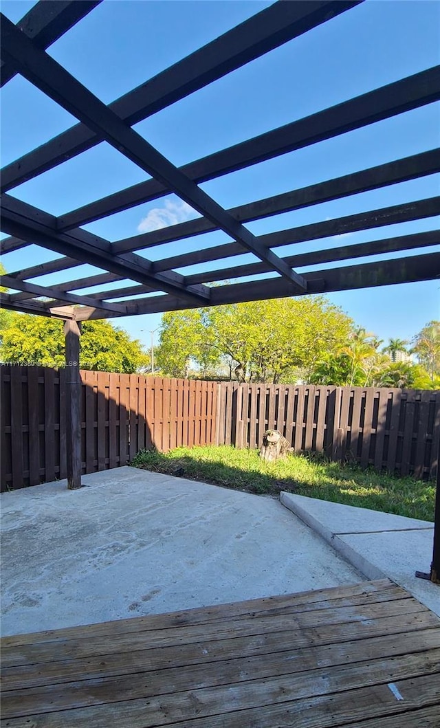 wooden deck with a patio and a pergola