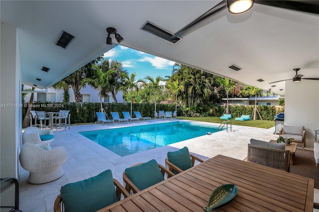 view of swimming pool featuring outdoor lounge area, a patio, and ceiling fan