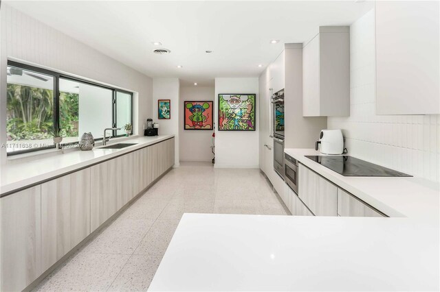 kitchen with black electric cooktop and sink