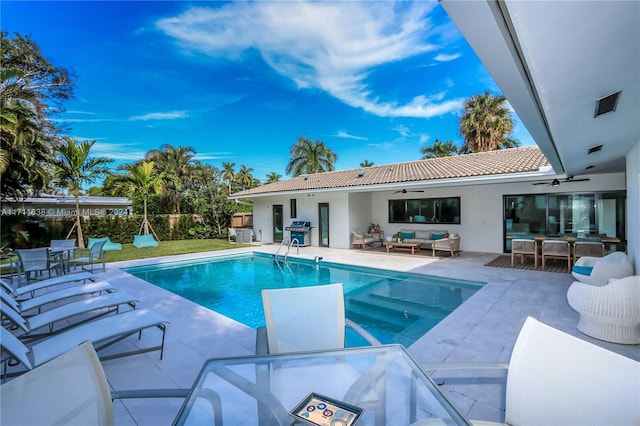 view of pool with ceiling fan, a patio area, an outdoor hangout area, and grilling area