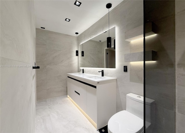 bathroom featuring vanity, toilet, and tile walls