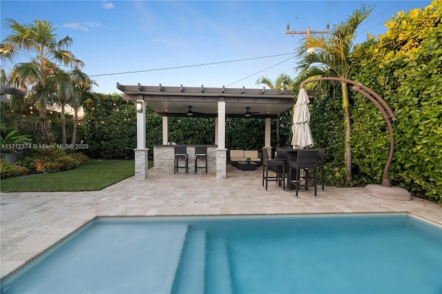 view of swimming pool with ceiling fan, outdoor lounge area, and a patio