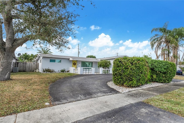 single story home with central air condition unit and a front lawn