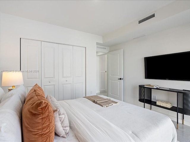 bedroom featuring a closet and visible vents