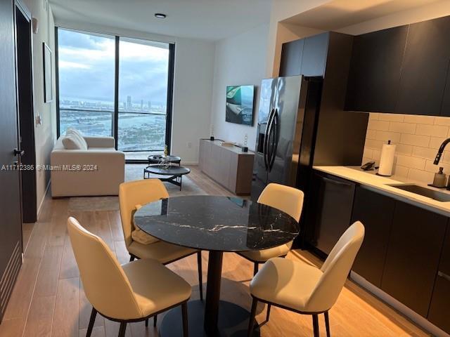 dining space featuring light hardwood / wood-style flooring and sink