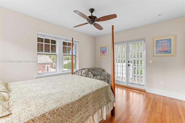 bedroom with ceiling fan, hardwood / wood-style floors, baseboards, and access to outside