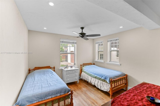 bedroom featuring a ceiling fan, recessed lighting, wood finished floors, and baseboards