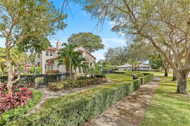 surrounding community with a fenced front yard, a yard, and a gate