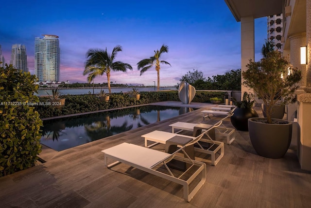 view of pool at dusk