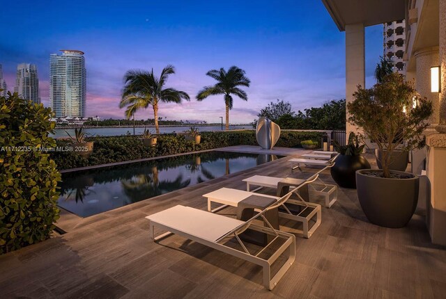 view of pool at dusk