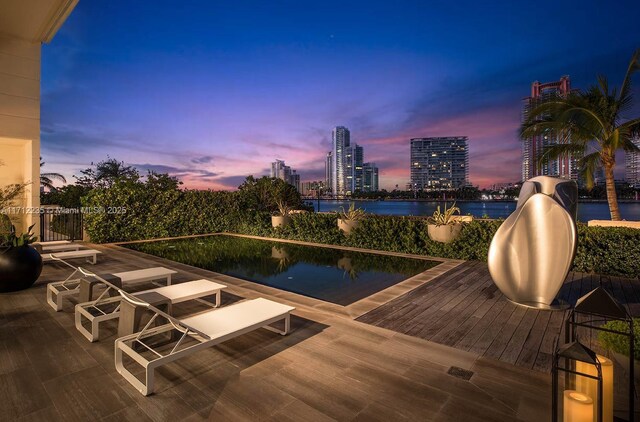 view of pool at dusk