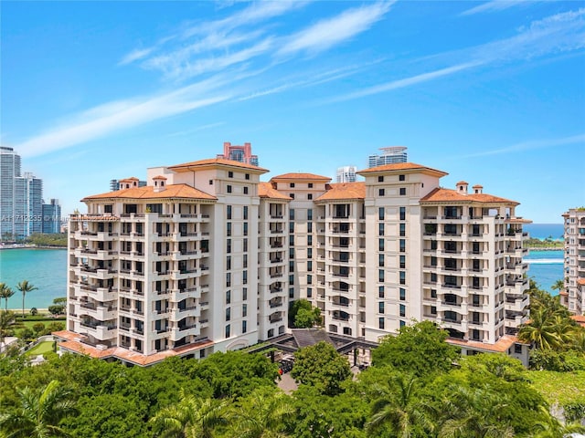 view of building exterior featuring a view of city and a water view