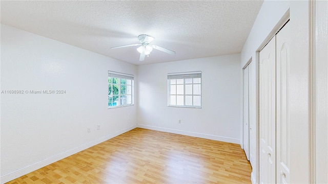 unfurnished bedroom featuring a textured ceiling, hardwood / wood-style flooring, and ceiling fan