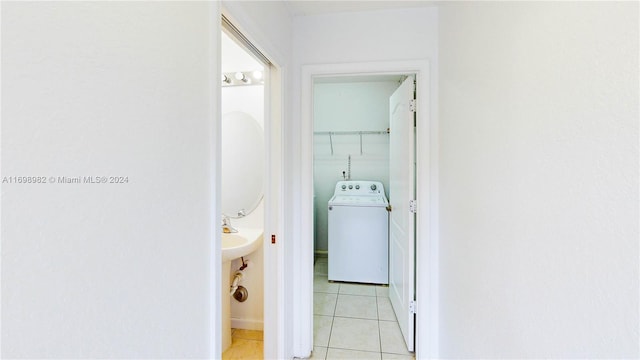 hallway featuring light tile patterned floors and washer / clothes dryer