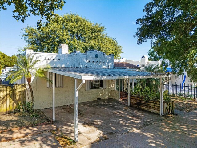 back of property with a patio