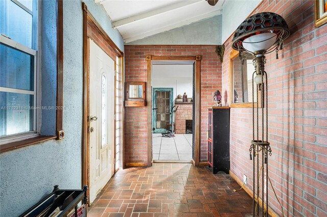 corridor with brick wall and vaulted ceiling