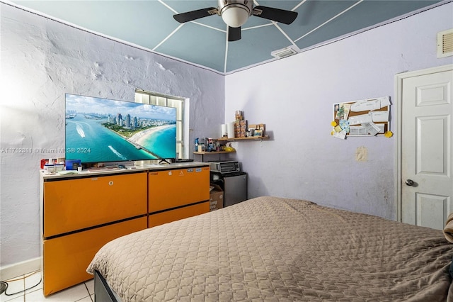 bedroom with ceiling fan and light tile patterned floors