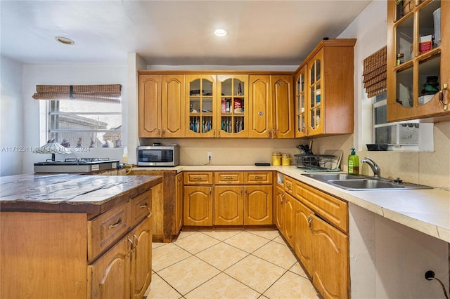 kitchen featuring light tile patterned floors and sink