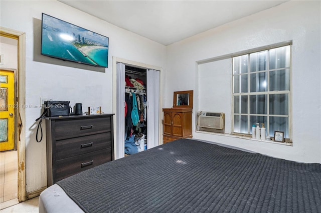 bedroom with cooling unit and a closet