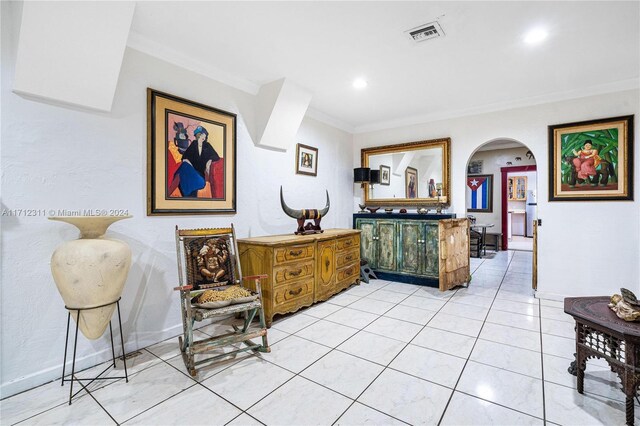 sitting room featuring light tile patterned floors and ornamental molding