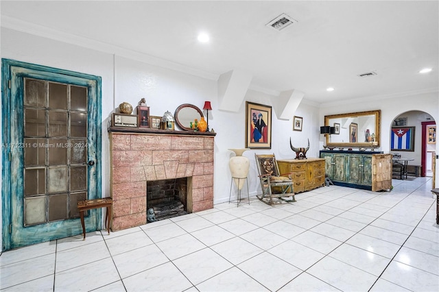 living room featuring tile patterned flooring, a stone fireplace, and crown molding