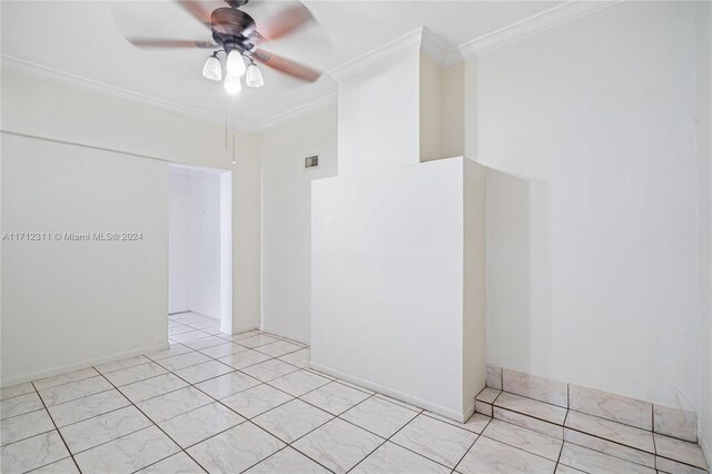 empty room with ceiling fan, light tile patterned floors, and ornamental molding