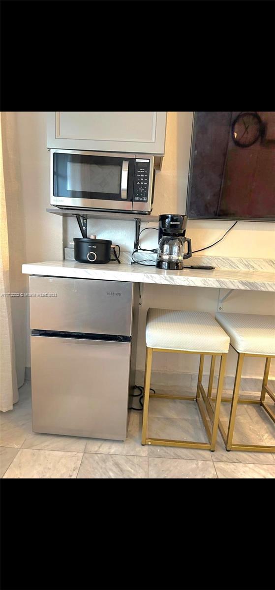 kitchen with appliances with stainless steel finishes and light tile patterned floors