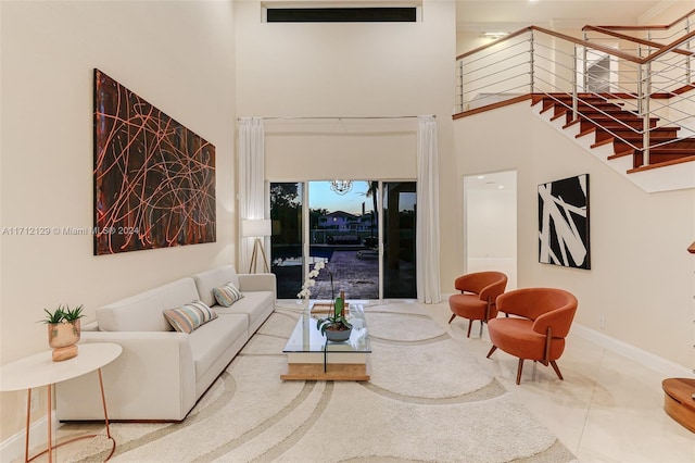 tiled living room with a towering ceiling