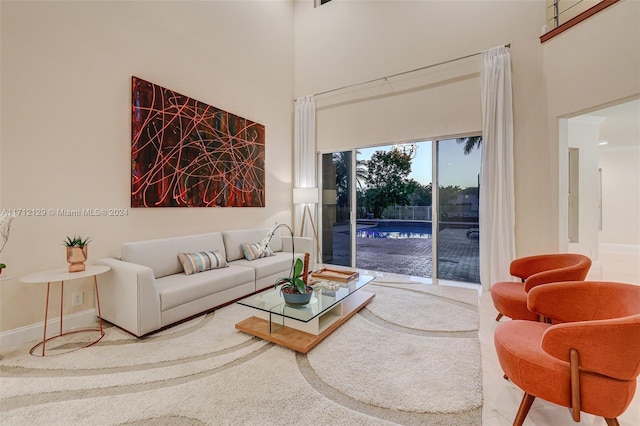 living room featuring a towering ceiling