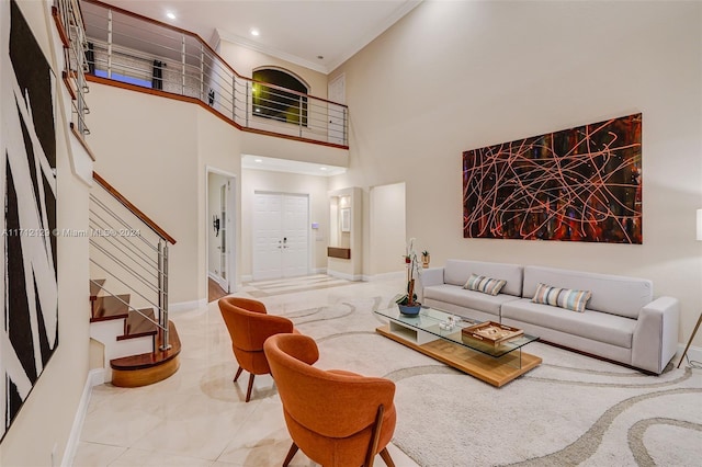 living room with a towering ceiling and ornamental molding