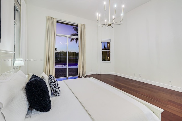 bedroom featuring hardwood / wood-style floors and a chandelier