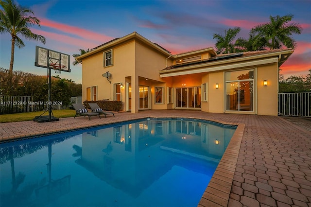 exterior space with a fenced in pool and a patio