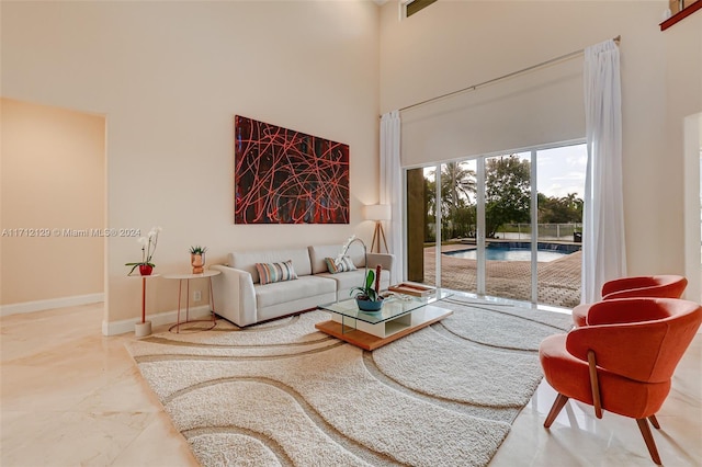 living room featuring a towering ceiling