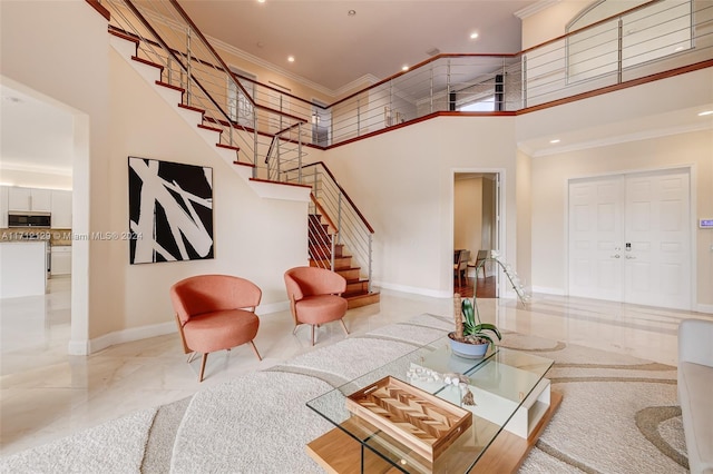 living room with a high ceiling and ornamental molding