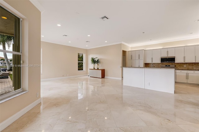 kitchen with decorative backsplash, crown molding, white cabinets, and stone countertops