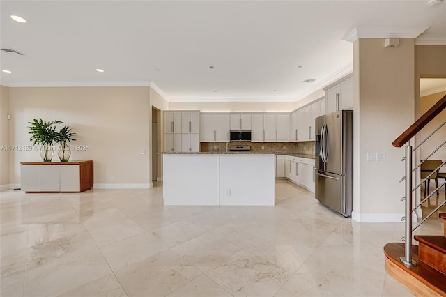 kitchen featuring white cabinetry, a center island, stainless steel appliances, tasteful backsplash, and ornamental molding