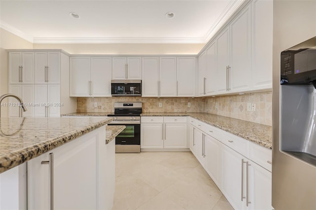 kitchen with stainless steel appliances, white cabinetry, tasteful backsplash, and light stone counters