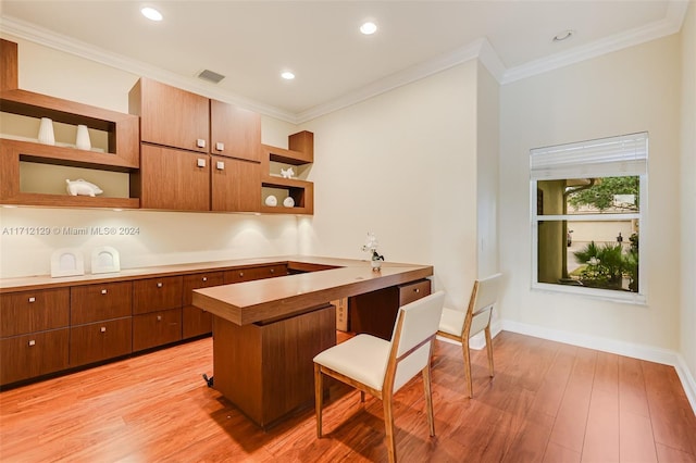 kitchen featuring a kitchen bar, crown molding, light wood-type flooring, and kitchen peninsula