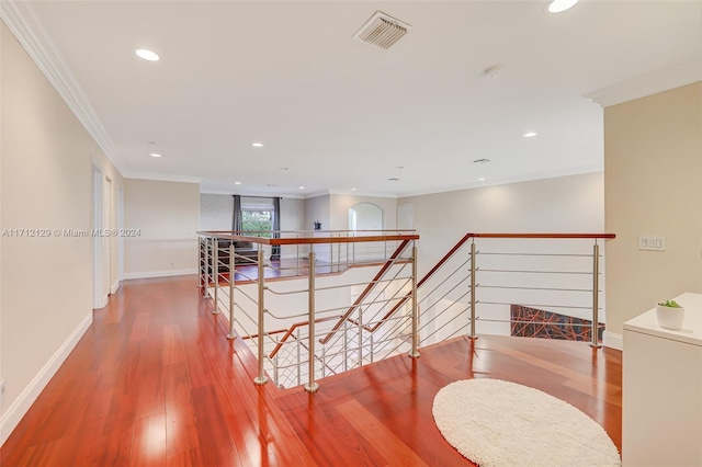 hall featuring hardwood / wood-style flooring and crown molding