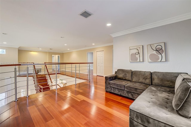 living room featuring crown molding and hardwood / wood-style flooring