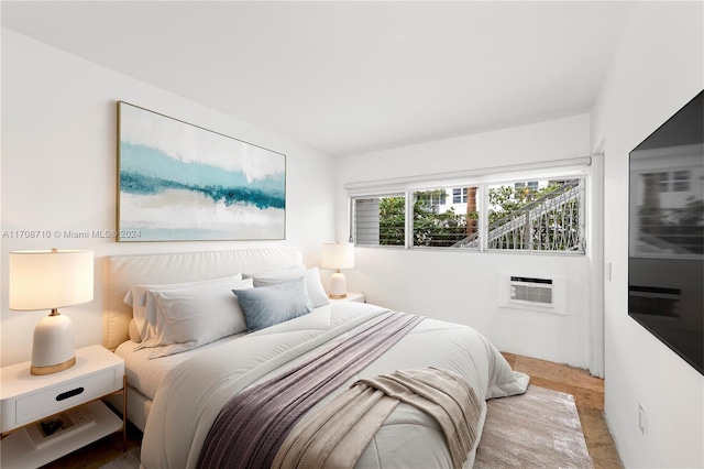 bedroom featuring an AC wall unit