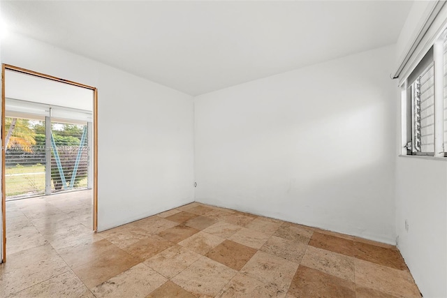1155 103rd St Unit 7A, Bay Harbor Islands, FL 33154 - empty room featuring stone tile flooring