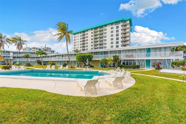 view of swimming pool with a lawn and a patio