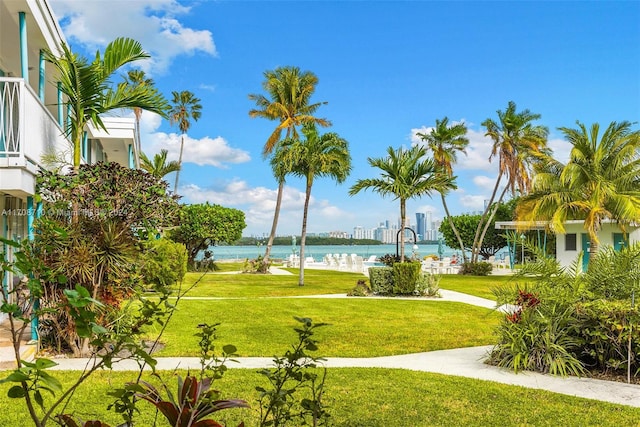 view of property's community with a yard and a water view